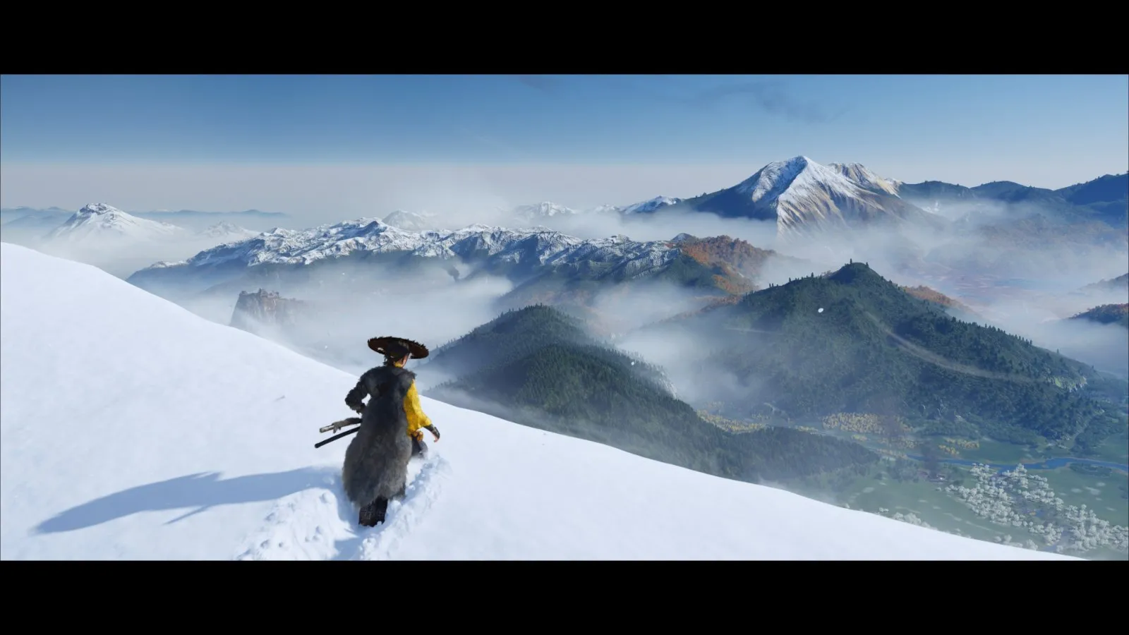Un paisaje de montañas nevadas en el Ezo de Ghost of Yōtei