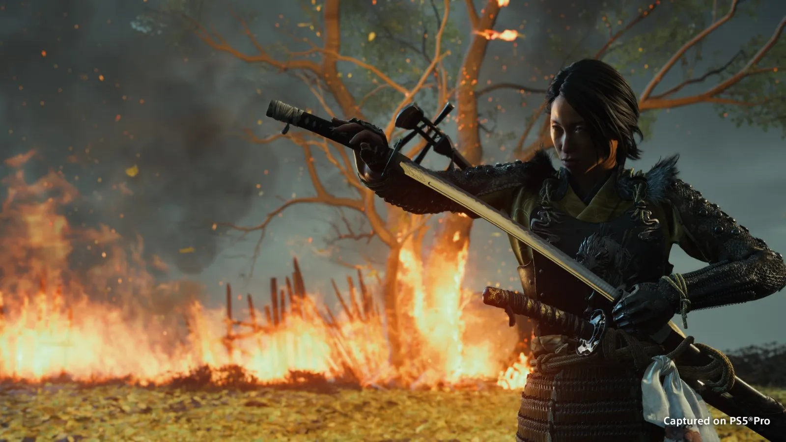 Atsu avanza con la katana entre llamas en Ghost of Yōtei