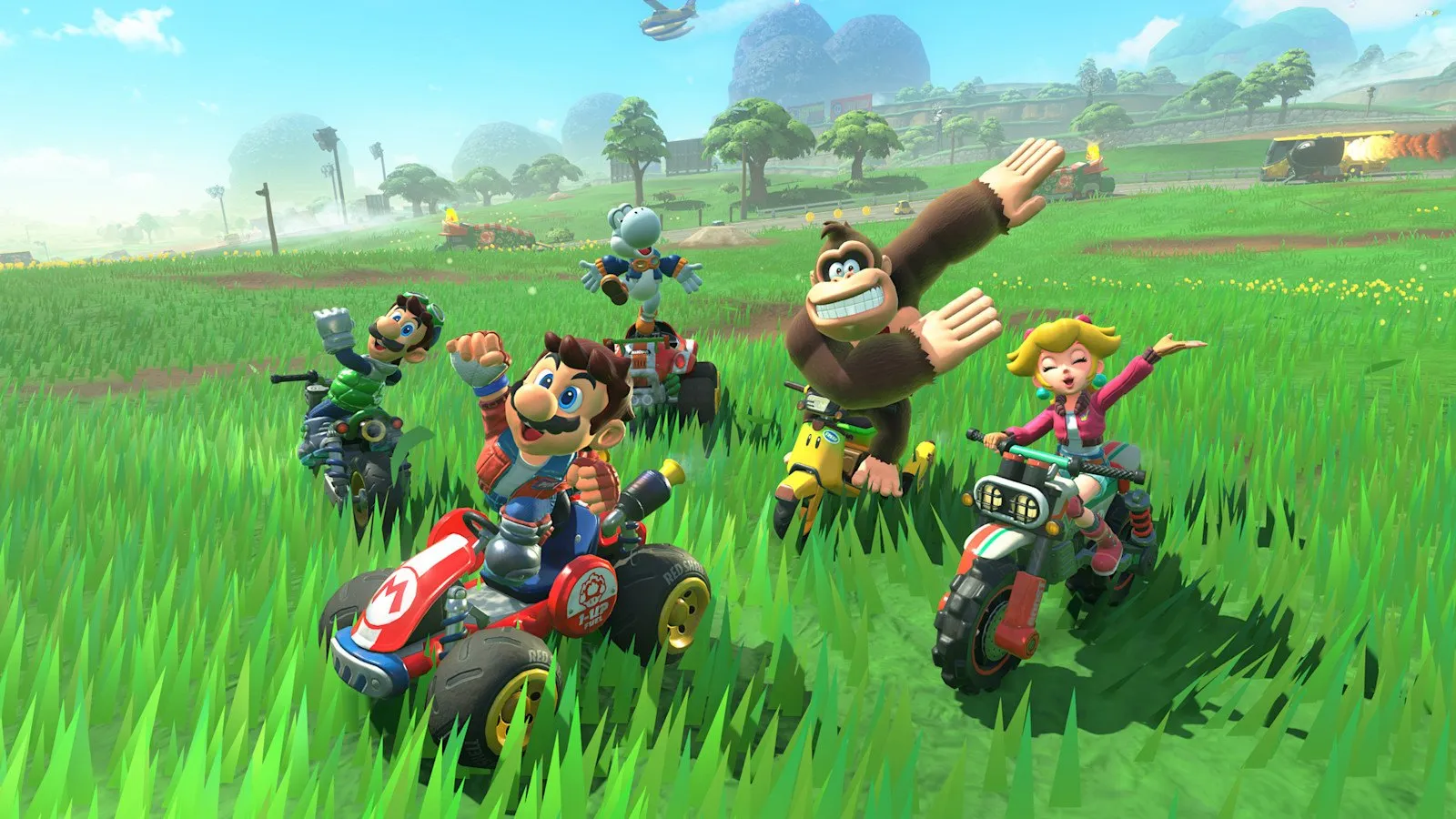 Varios pilotos atraviesan un prado con Donkey Kong y Bowser en Mario Kart World