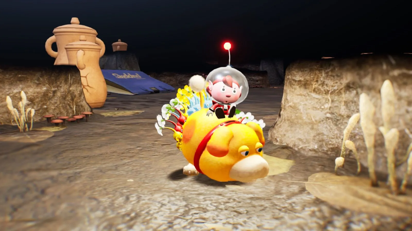El explorador monta a Oatchi, el perro espacial, entre ruinas en Pikmin 4
