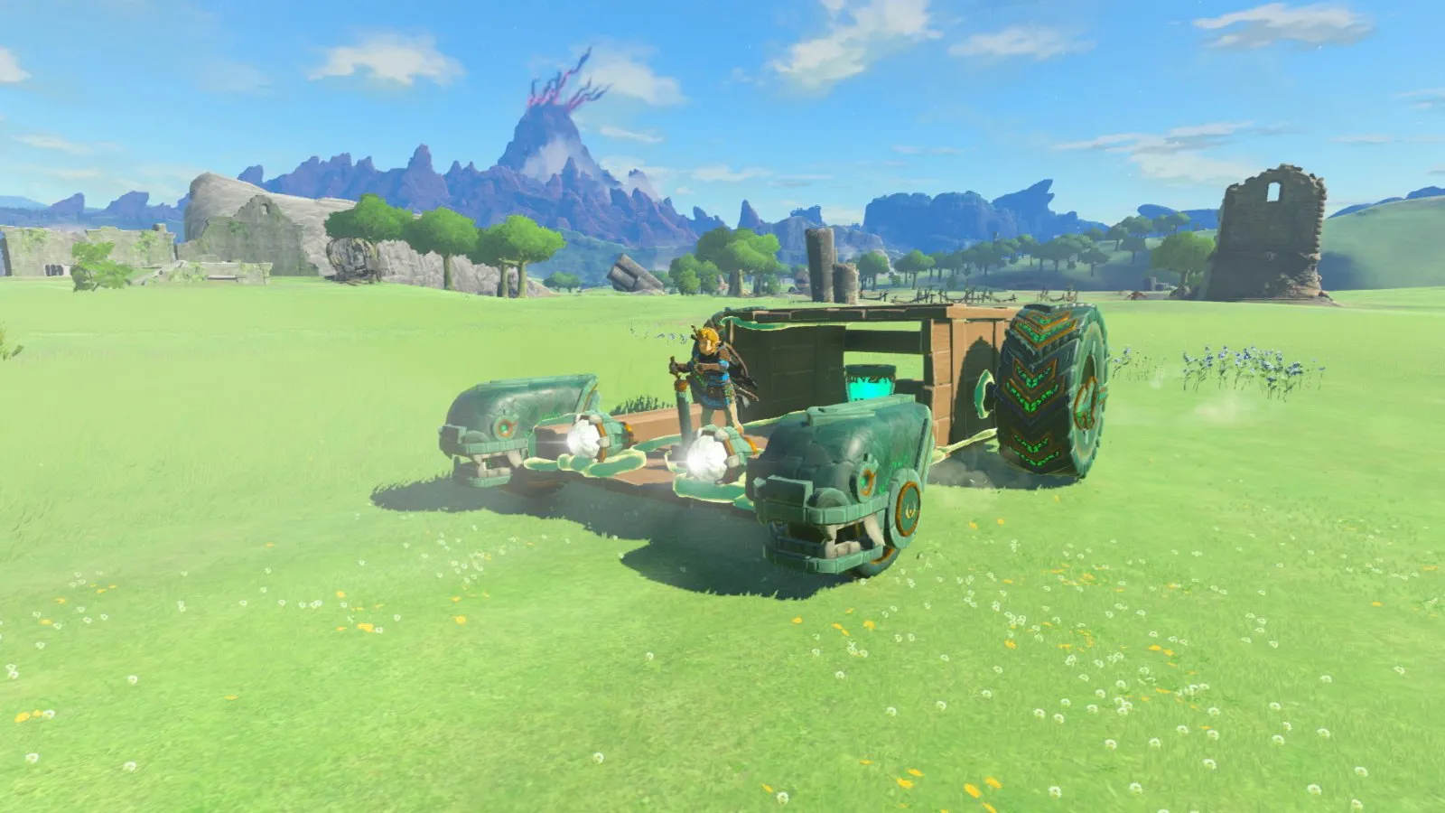 Un vehículo construido con piezas y ruedas en una pradera en The Legend of Zelda: Tears of the Kingdom