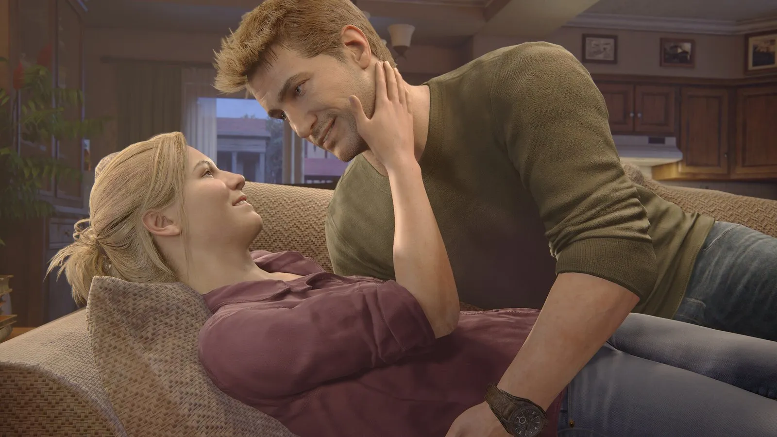 Nathan y Elena, tumbados en el sofá de su casa, comparten un momento tranquilo en Uncharted: Colección Legado de los Ladrones