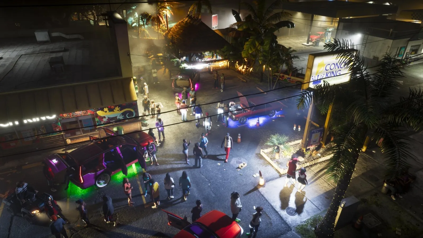 Una calle de Vice City de noche llena de gente y coches con luces de neón en Grand Theft Auto VI